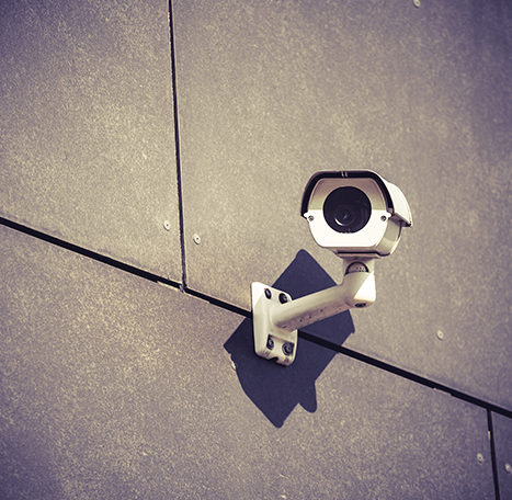 security-camera-on-gray-office-building-wall-PH7WVF9